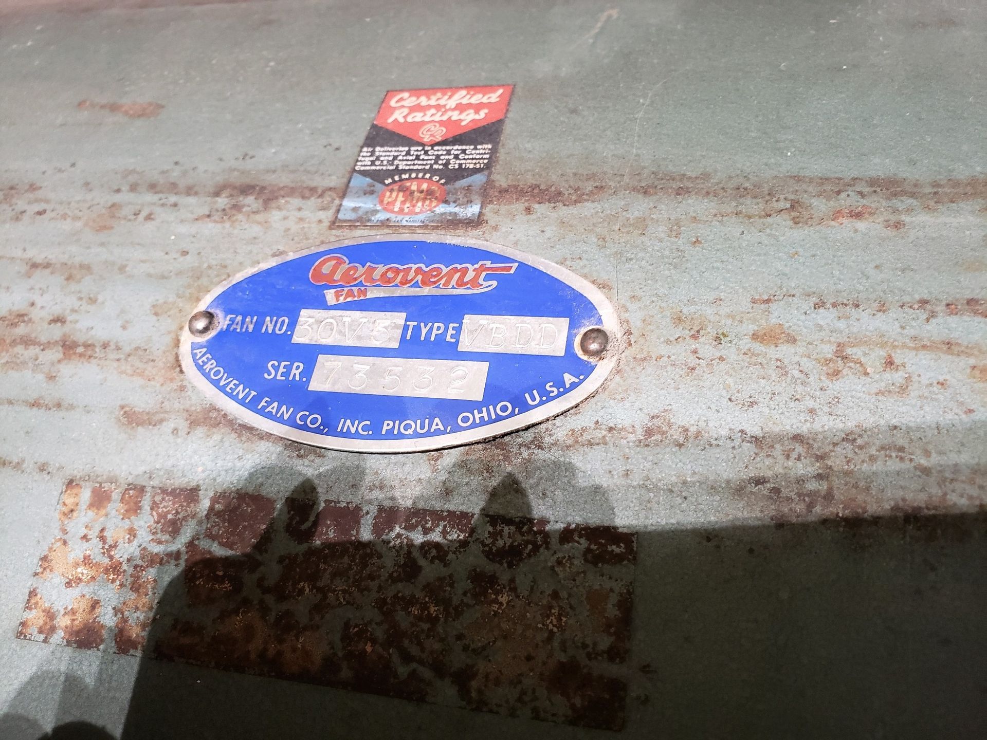 A close up of a plaque on a rusty metal surface