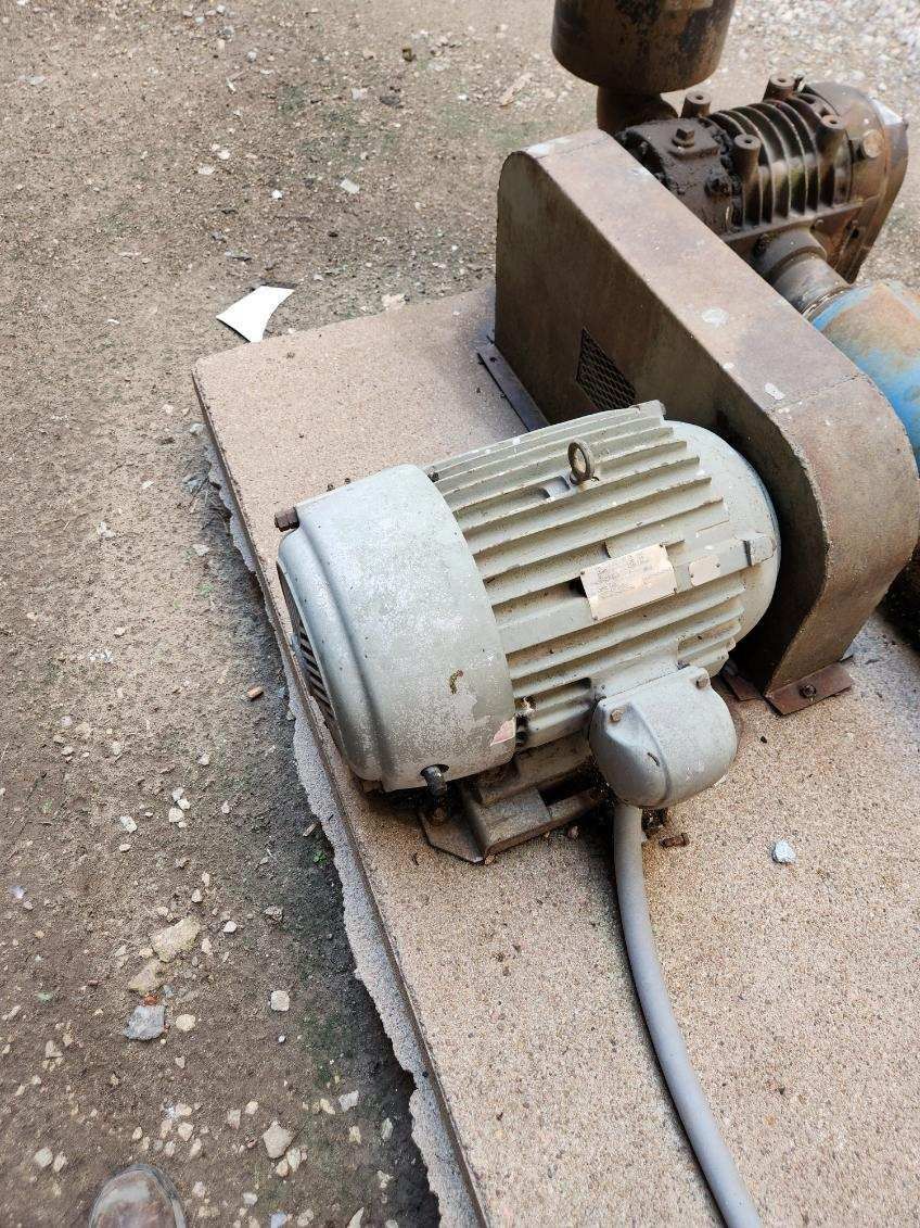 A motor is sitting on top of a piece of wood.