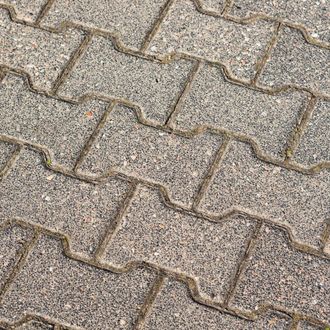 a close up of a brick pavement on a sidewalk .