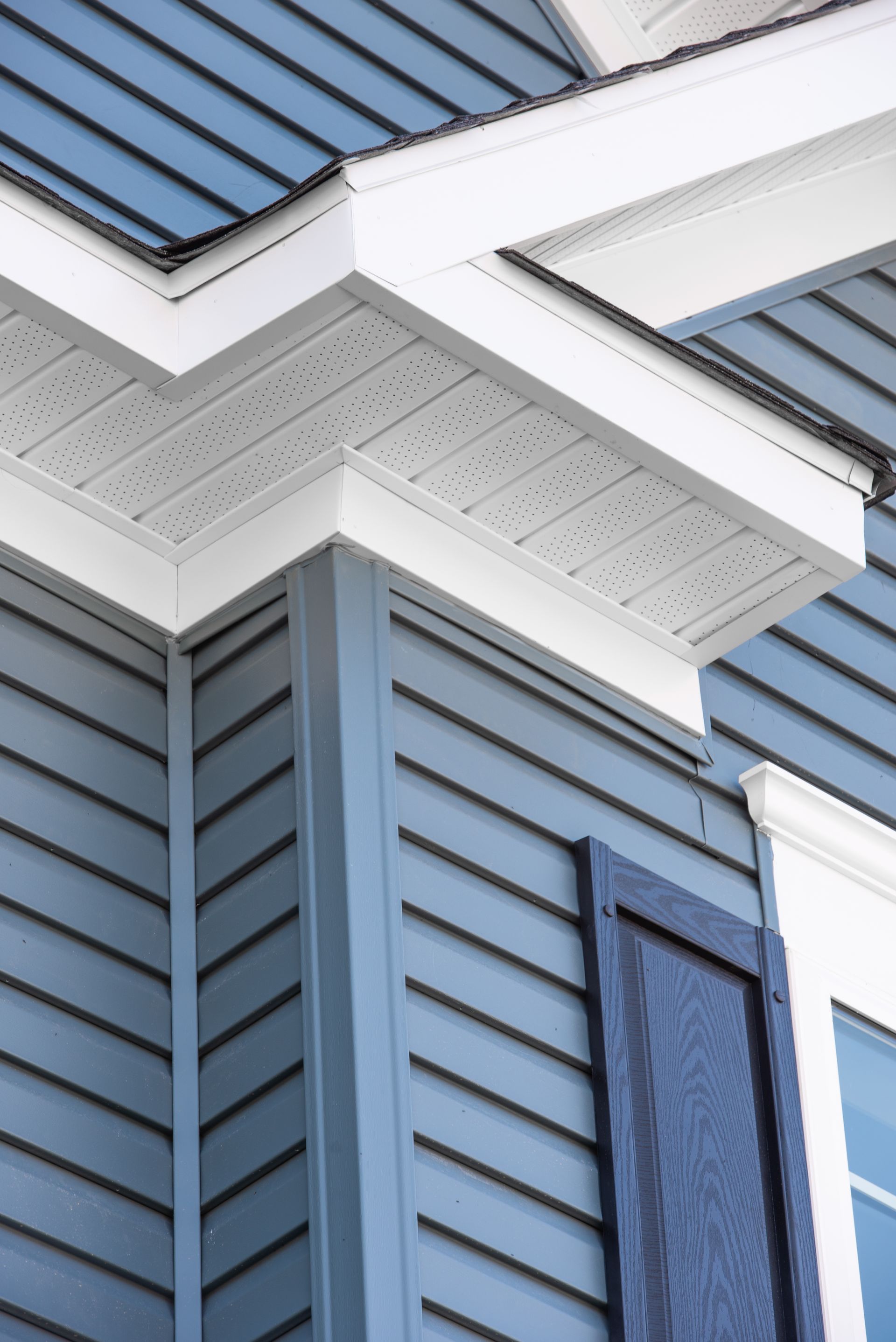 A close up of a blue siding on a house