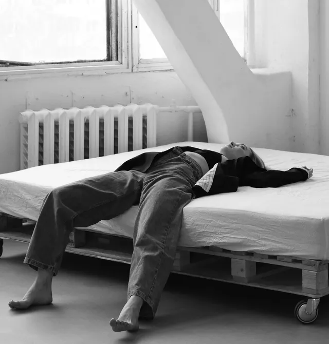 woman laying on mattress is happy in new apartment