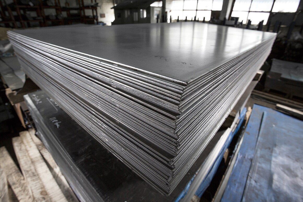 A Stack of Metal Sheets Sitting on Top of Each Other in a Factory — Sun City Sheetmetal In Garbutt, QLD