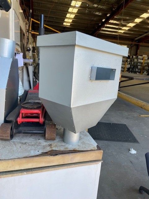 A gray container is sitting on a table next to a red jack.— Sun City Sheetmetal In Garbutt, QLD