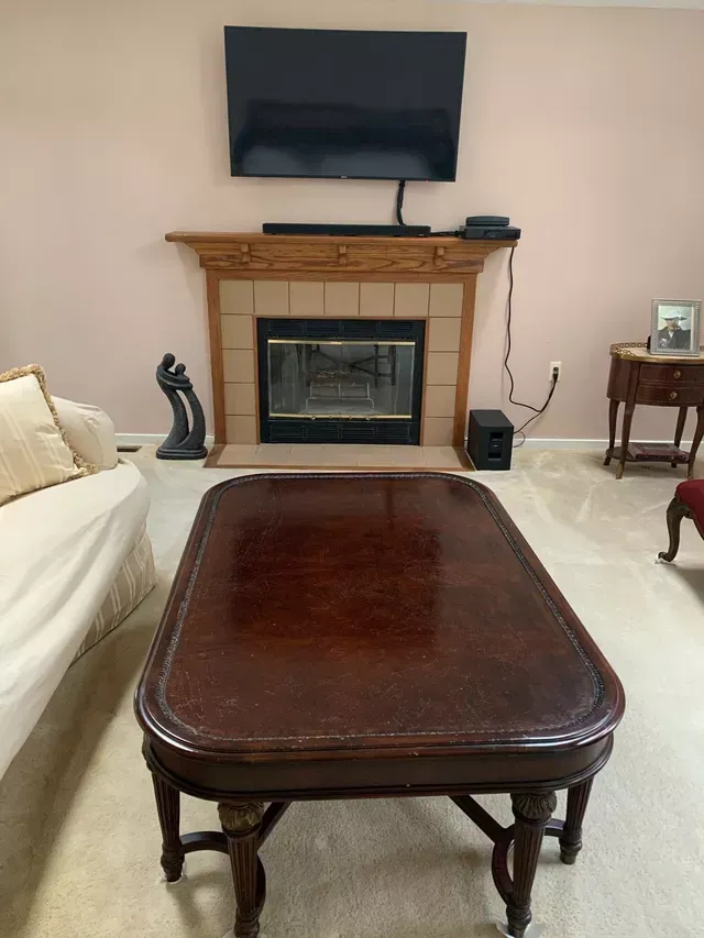 a living room with a fireplace and a coffee table