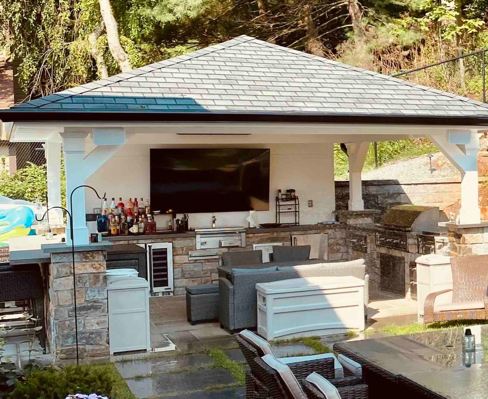 a gazebo with a large flat screen tv on the roof