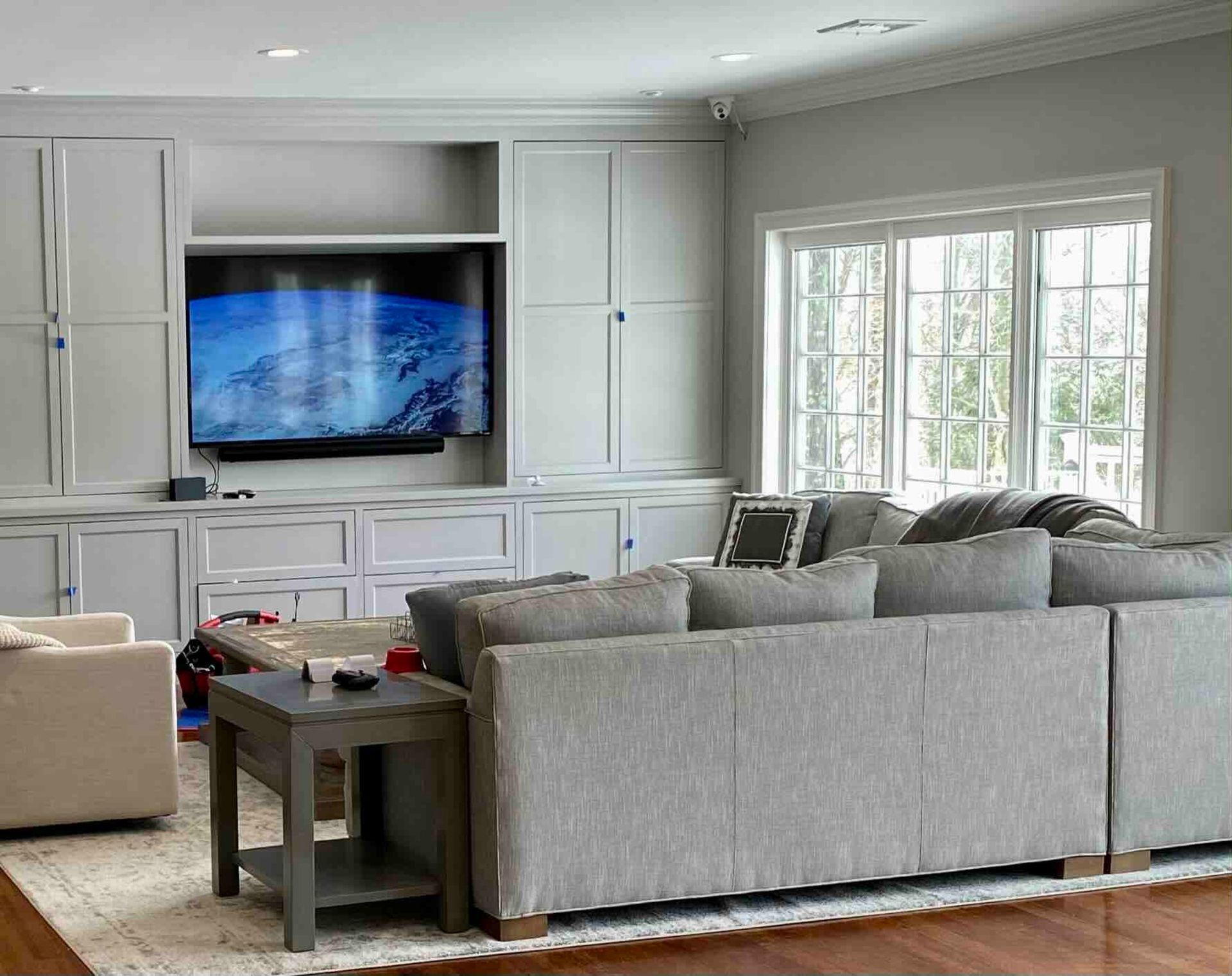 a living room with a couch and a newly installed flat screen tv