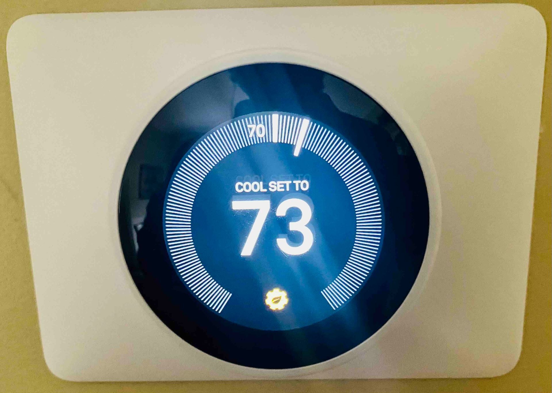 a newly installed thermostat with the number 73 on it