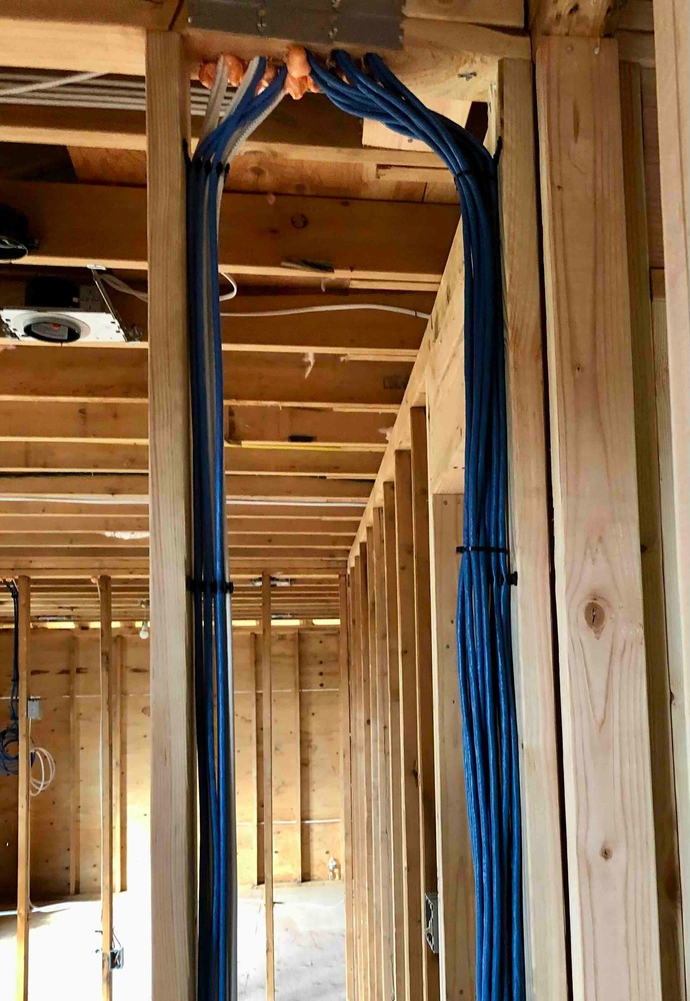 a wooden staircase is being built in a house under construction with the wiring for networking