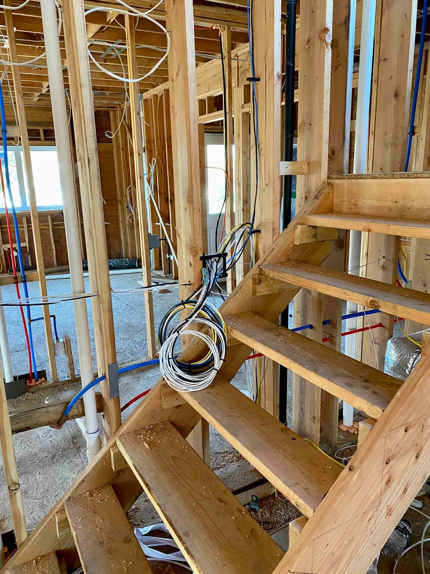 a wooden staircase is being built in a house under construction and the wiring for networking