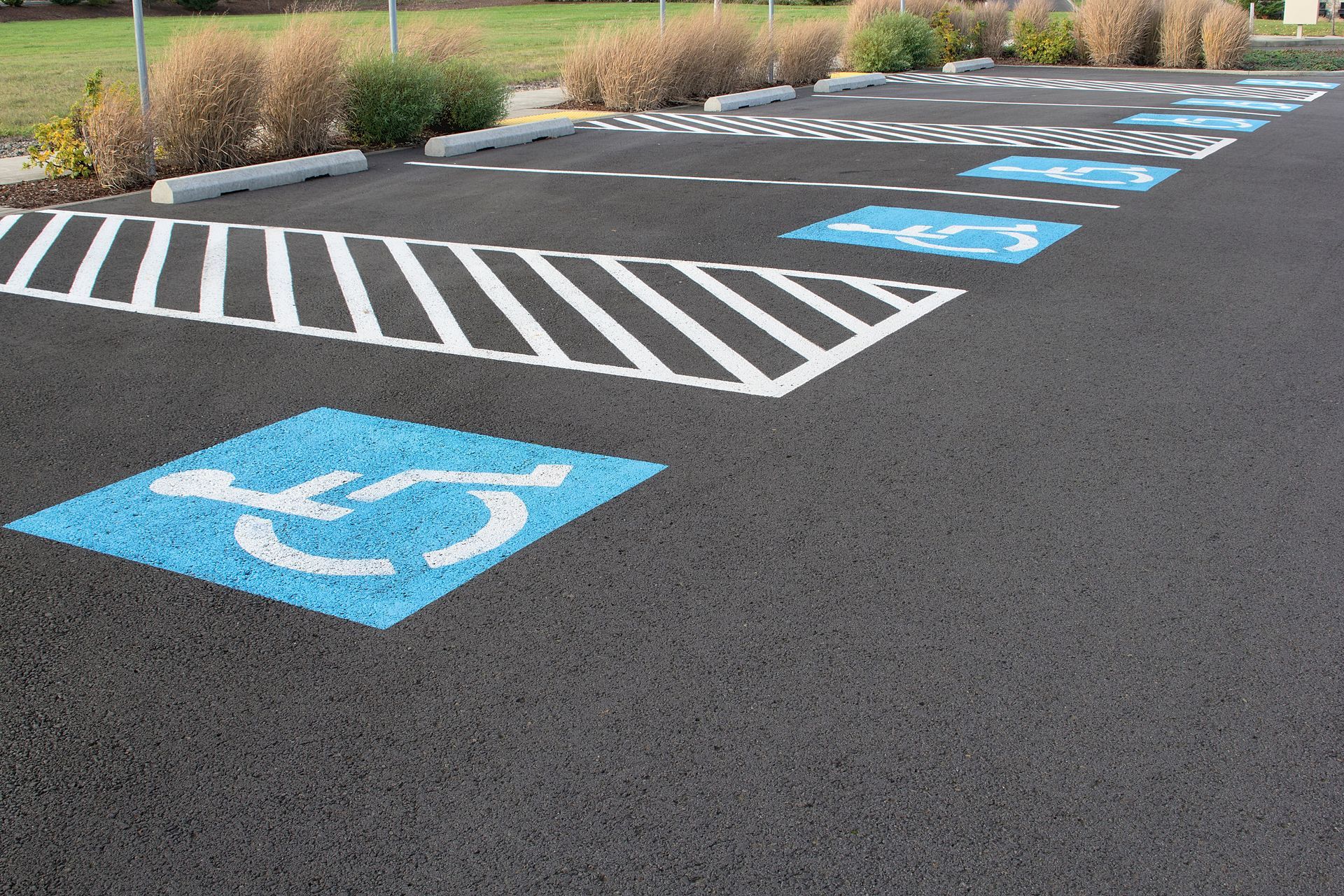 Accessible parking spaces marked with blue wheelchair symbols in a paved lot