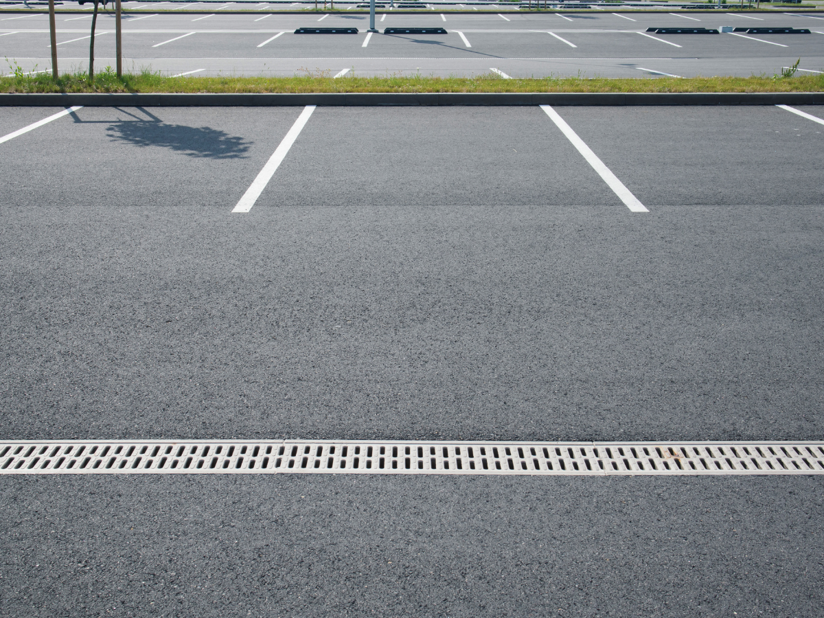 There is a drain in the middle of the parking lot.