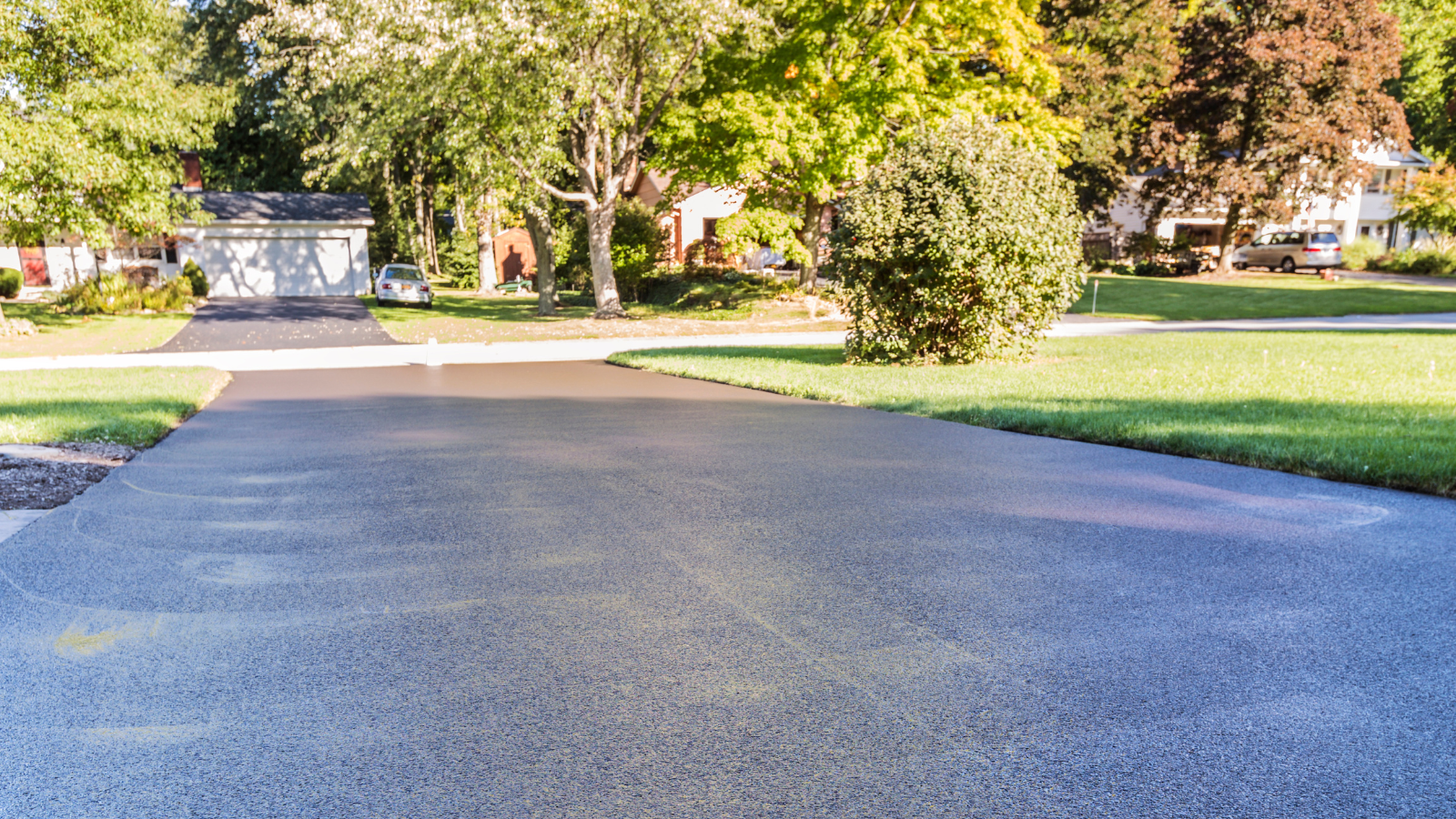 A driveway leading to a house in a residential neighborhood.