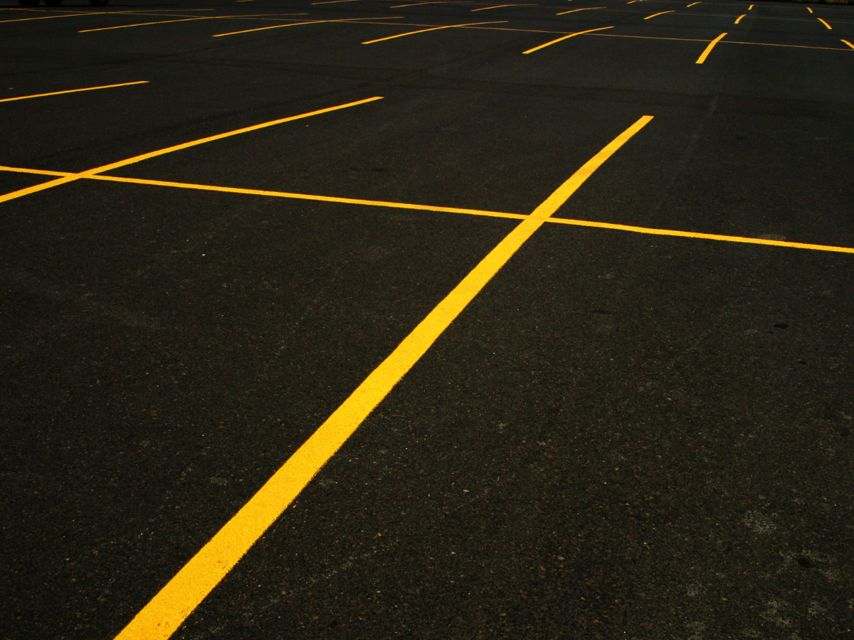 A parking lot with yellow lines on it