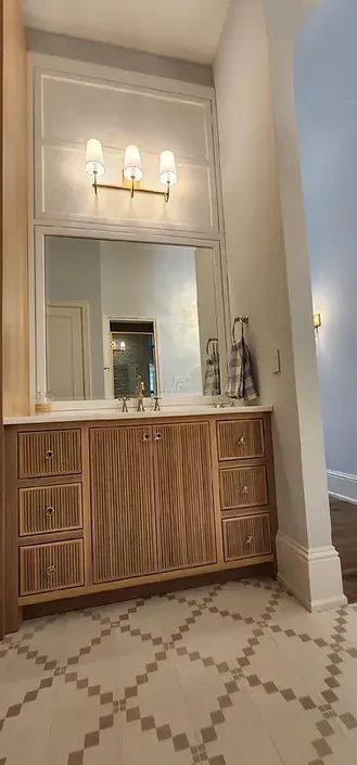 A bathroom with two sinks and a large mirror.