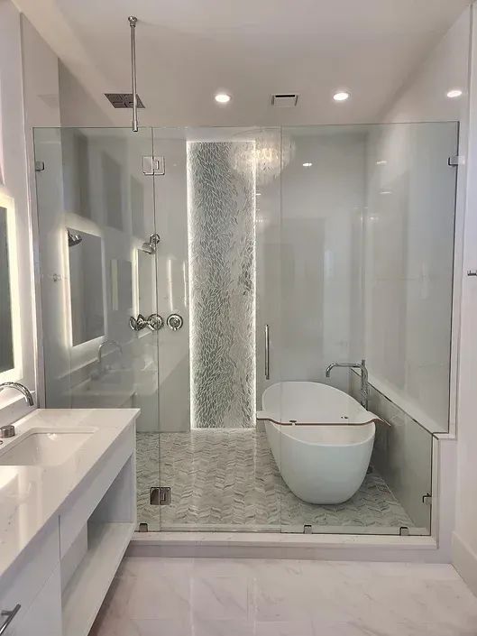 A bathroom with a bathtub , sink , shower and mirror.