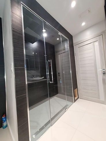 A bathroom with sliding glass doors and a sink.