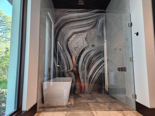 A bathroom with a walk in shower and a bathtub.