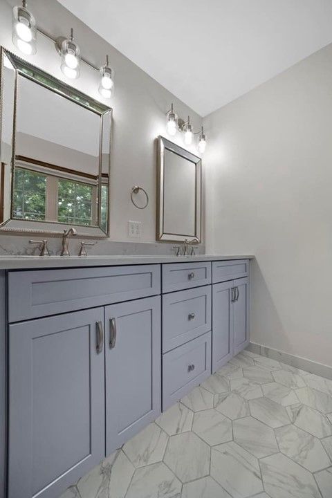 A bathroom with two sinks and a mirror.