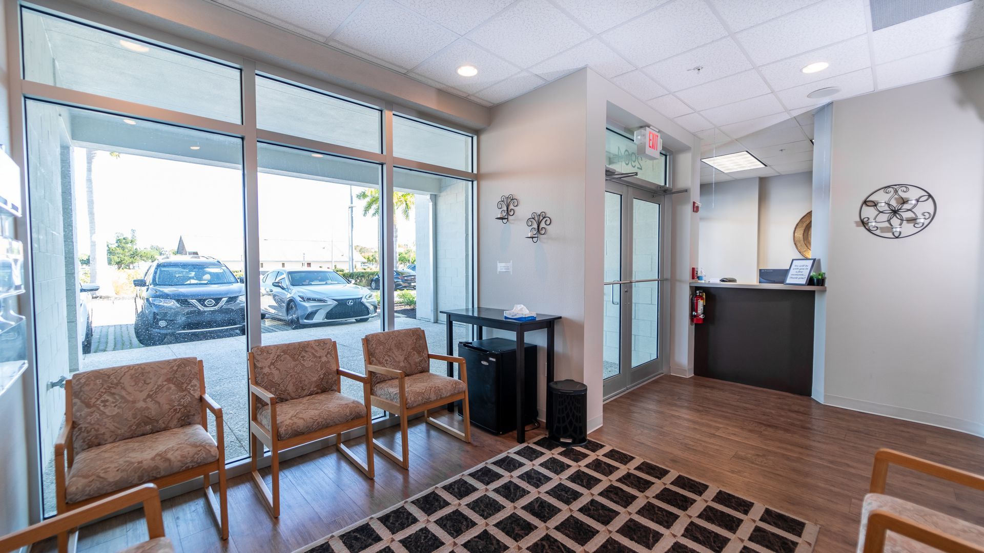 A waiting room with chairs and a rug in a dental office.