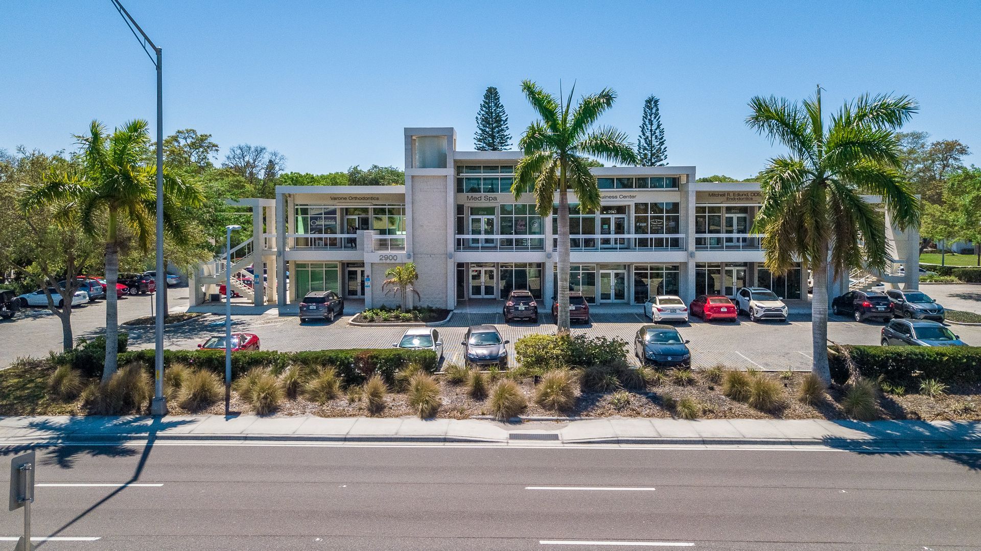 An aerial view of a building with cars parked in front of it.