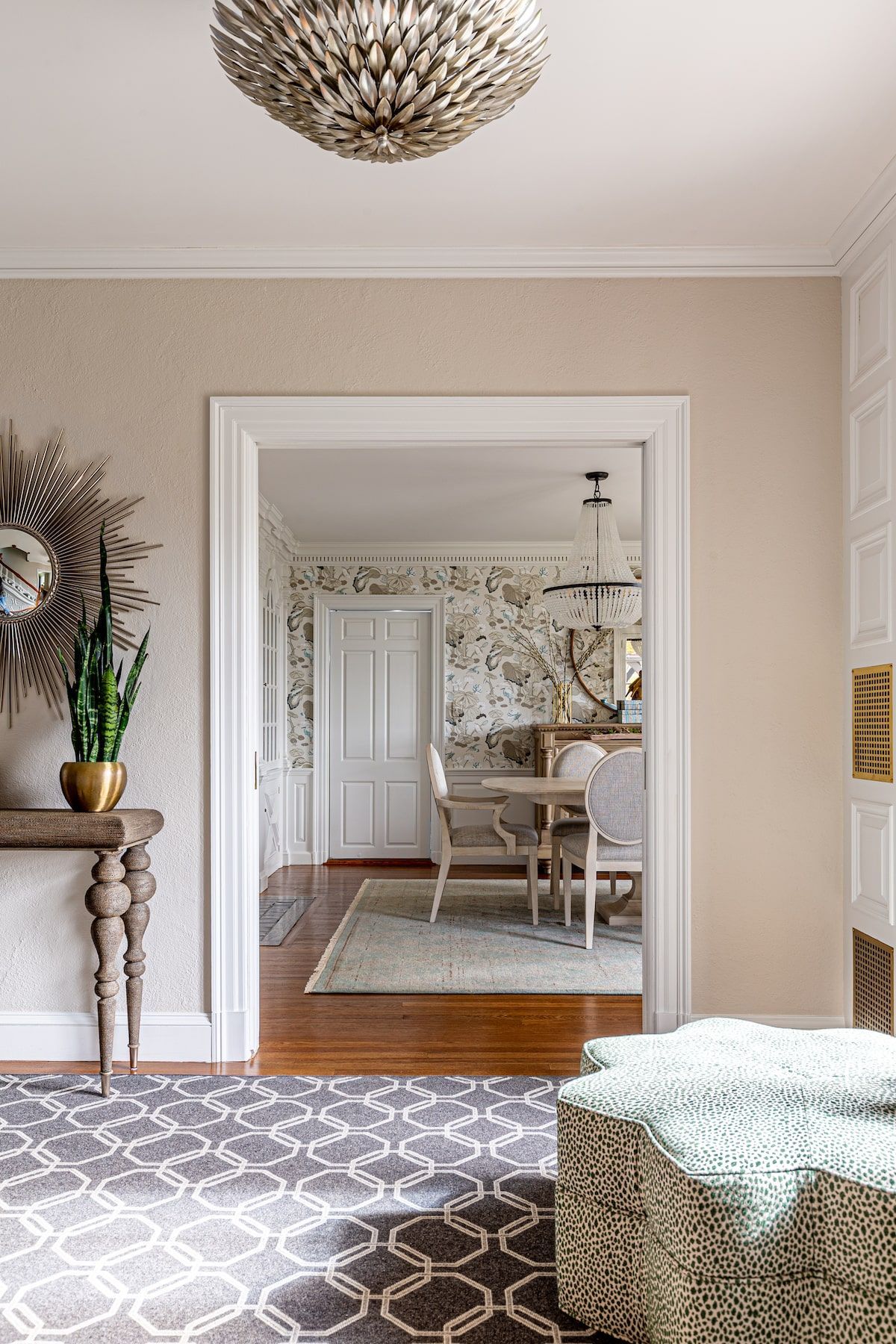 Elegant dining room interior viewed from a hallway, featuring a table set for a meal.