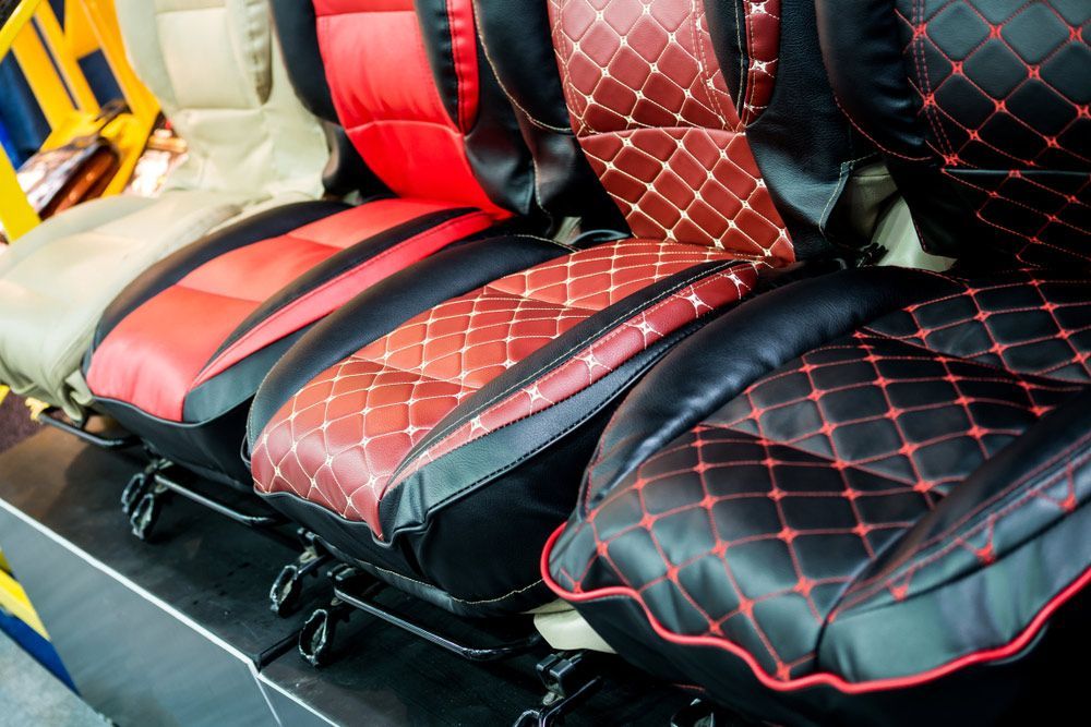 A Row Of Car Seat Covers Are Lined Up In A Row — Gaeta's Upholstery Blinds & Awnings in Yamba, NSW