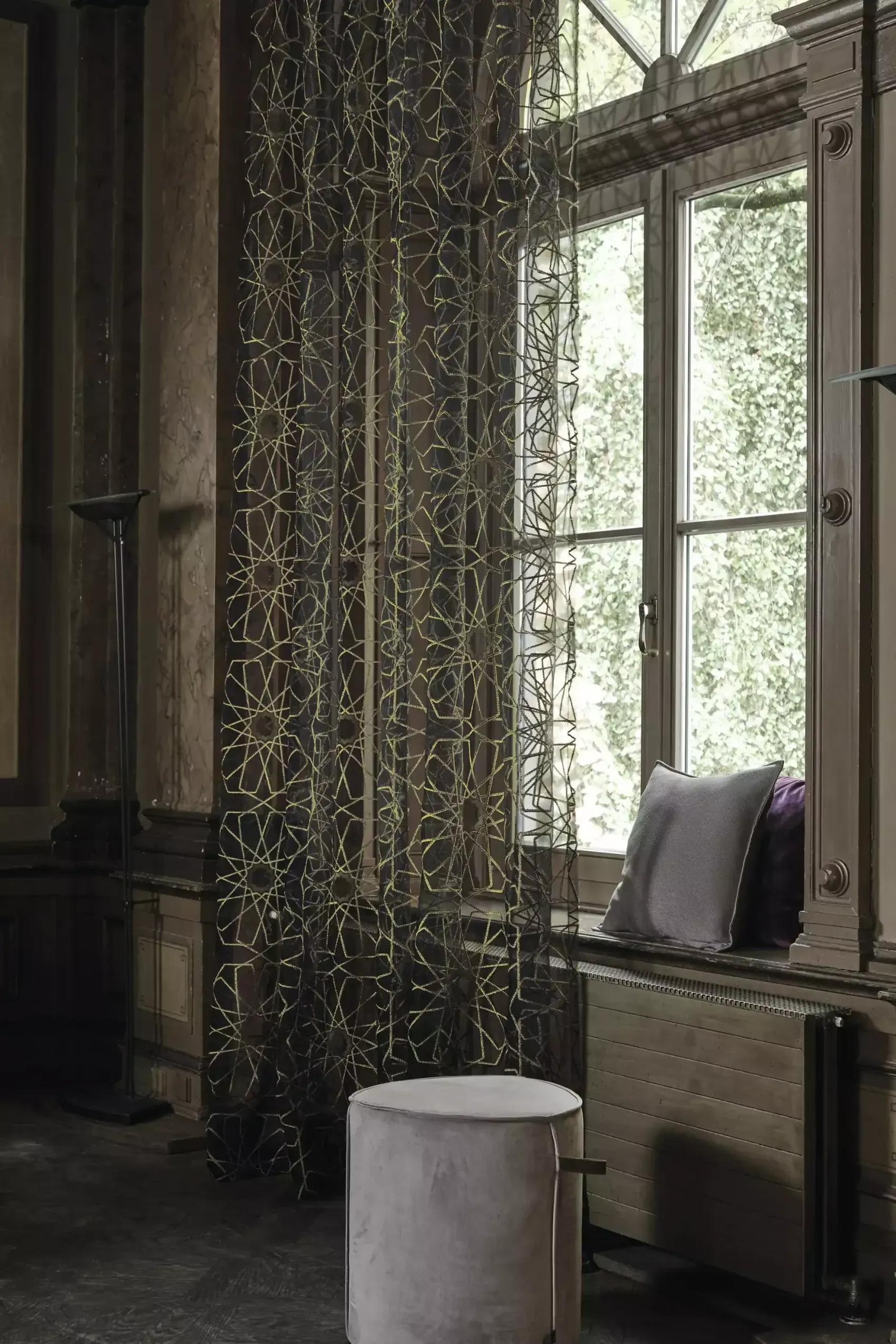 A Person Is Holding A Yellow Duster In Front Of A Window — Gaeta's Upholstery Blinds & Awnings in Glen Innes, NSW