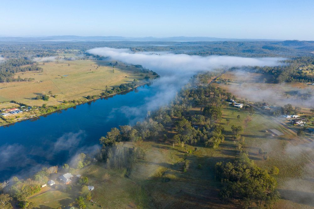 An Aerial View Of A River Surrounded By Trees And Fog — Gaeta's Upholstery Blinds & Awnings in Grafton, NSW