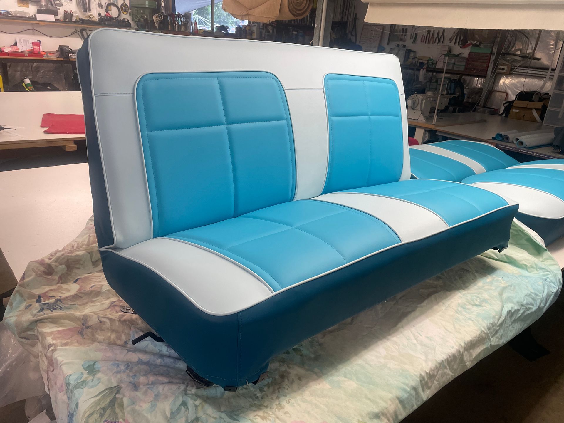 A White Boat With Brown Seats Is In The Water — Gaeta's Upholstery Blinds & Awnings in Grafton, NSW