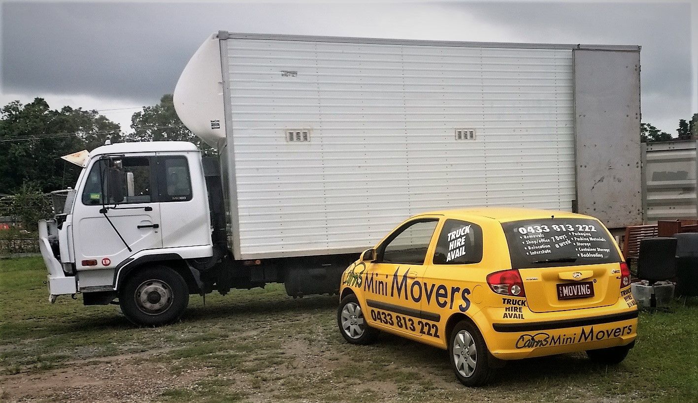 A White Moving Truck and a Yellow Car — Cairns Mini Movers In Mount Sheridan, QLD