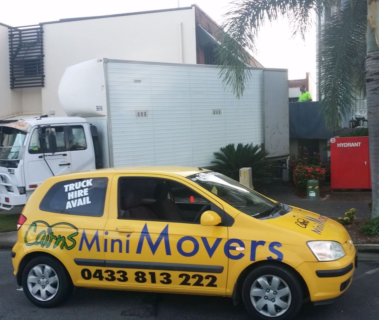 Two Men Carry Large Cardboard Boxes — Cairns Mini Movers In Mount Sheridan, QLD