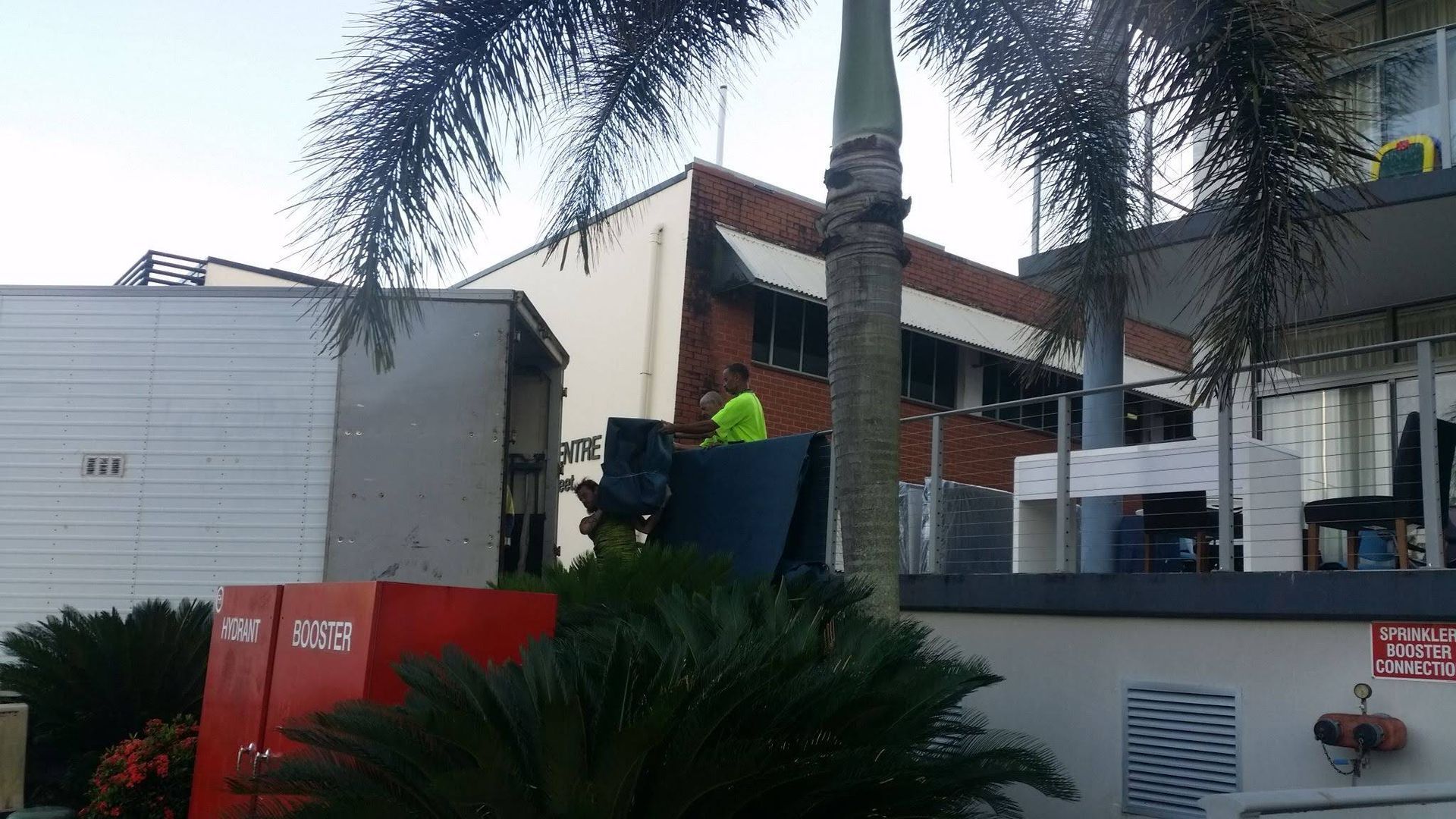 Workers Unload Equipment From a Truck — Cairns Mini Movers In Mount Sheridan, QLD