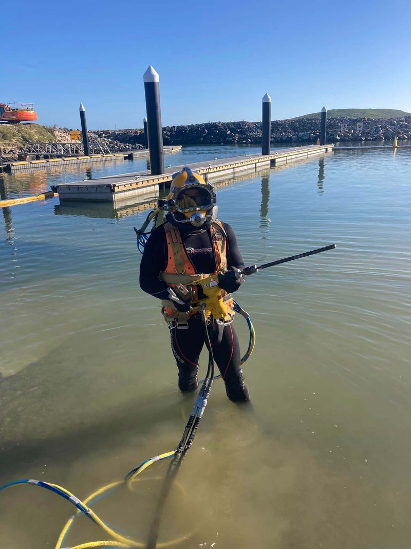 Diver holding a driller underwater