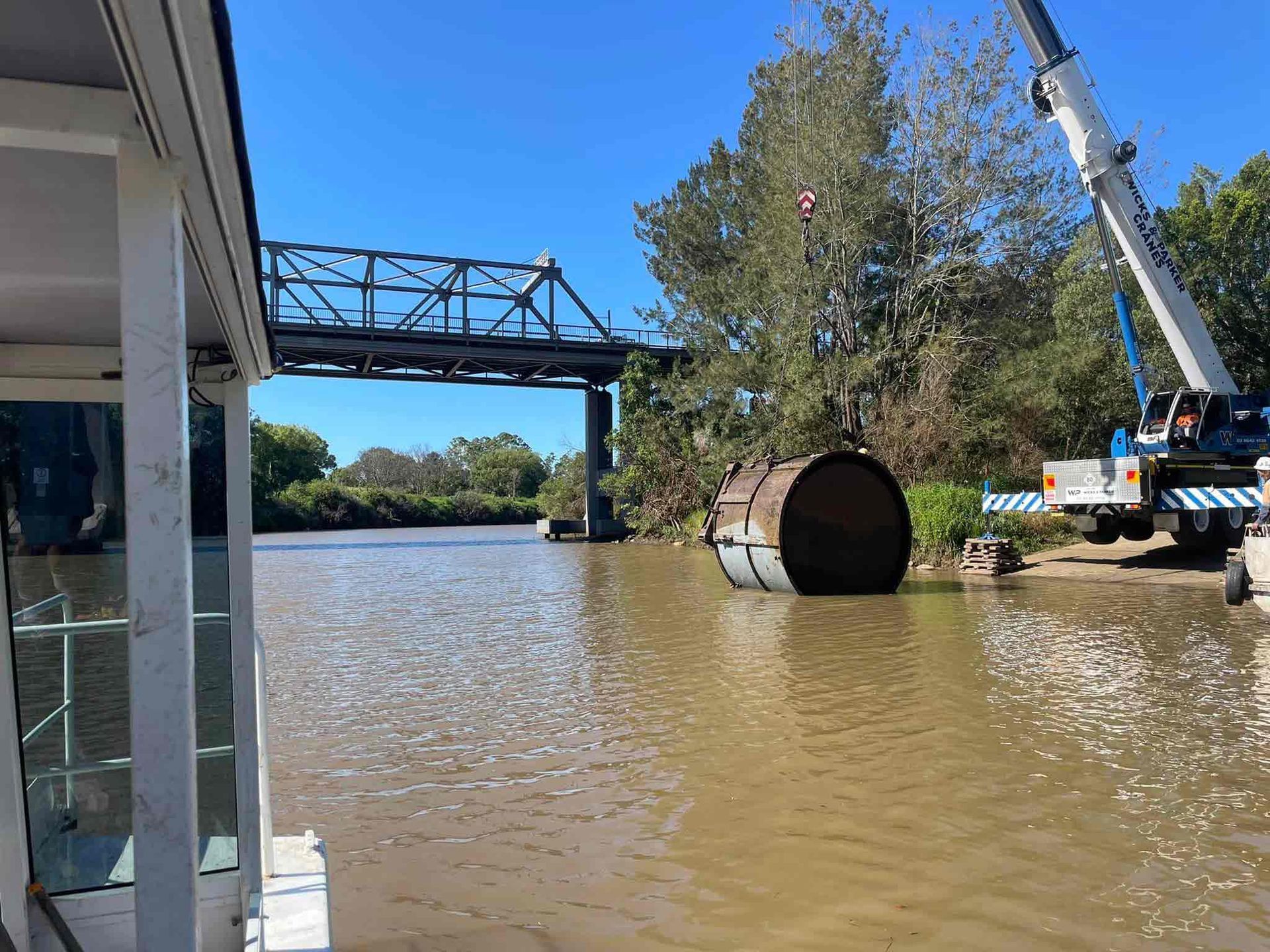 Lifting big metal in the water using a crane — Marine Construction Mid North Coast, NSW