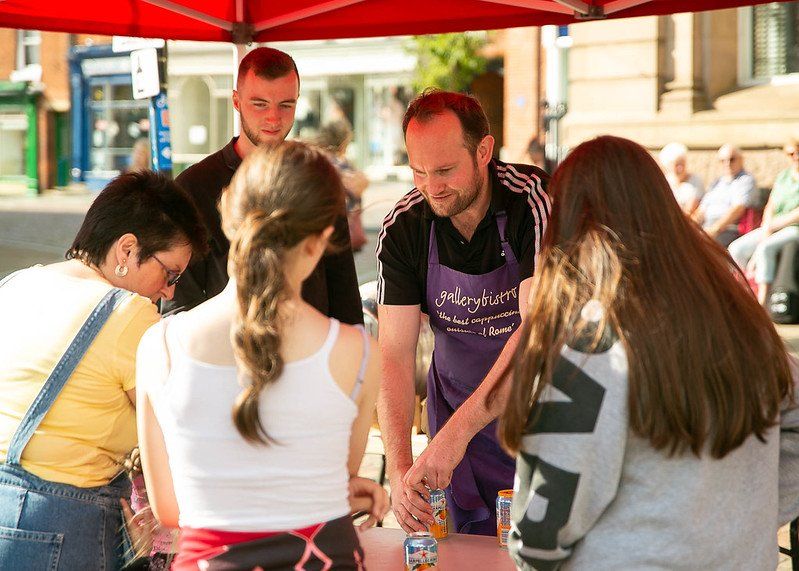 Some people purchasing drinks at the Fakenham Music Festival