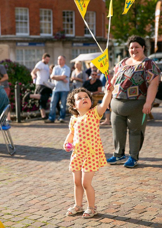 Little girl enjoying the music at the Fakenham Music Festival