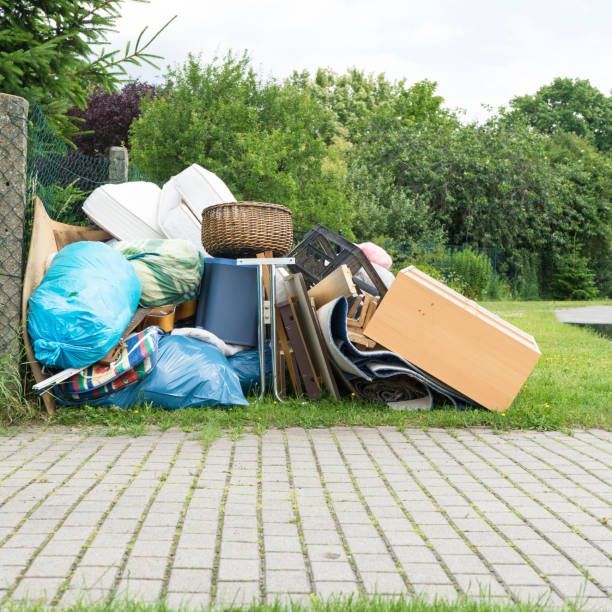A pile of trash is sitting on the side of the road.