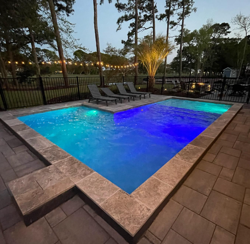 A large swimming pool designed and installed by Carolina Pool Plastering in Pineville, NC