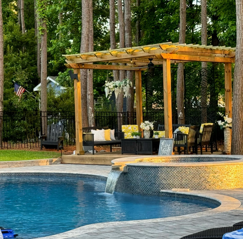 A large inground swimming pool and spa with water features installed by Caroline Pool Plastering in Huntsville, NC