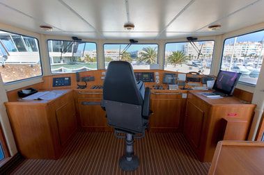 A yacht cabin fitted with teak interior floors and cabinets