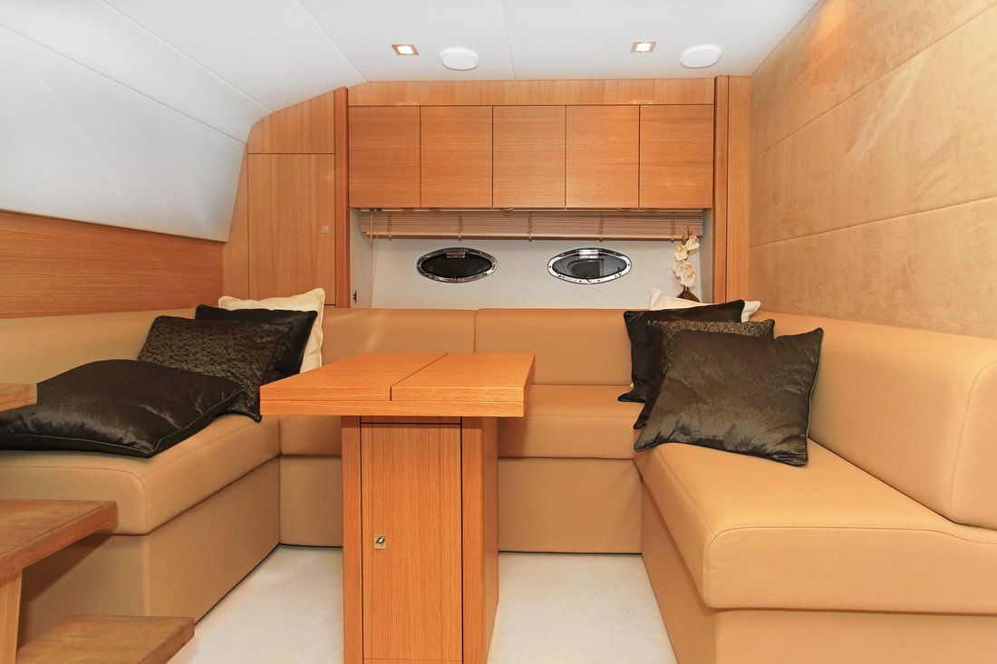 small internal cabin of a medium size yacht with custom table and cabinets