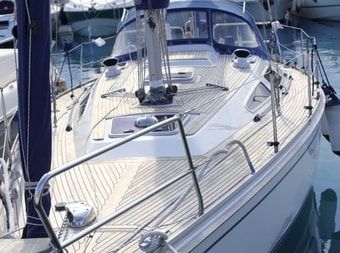 30 ft sailboat with teak deck painted white to match the design of the rest of the boat