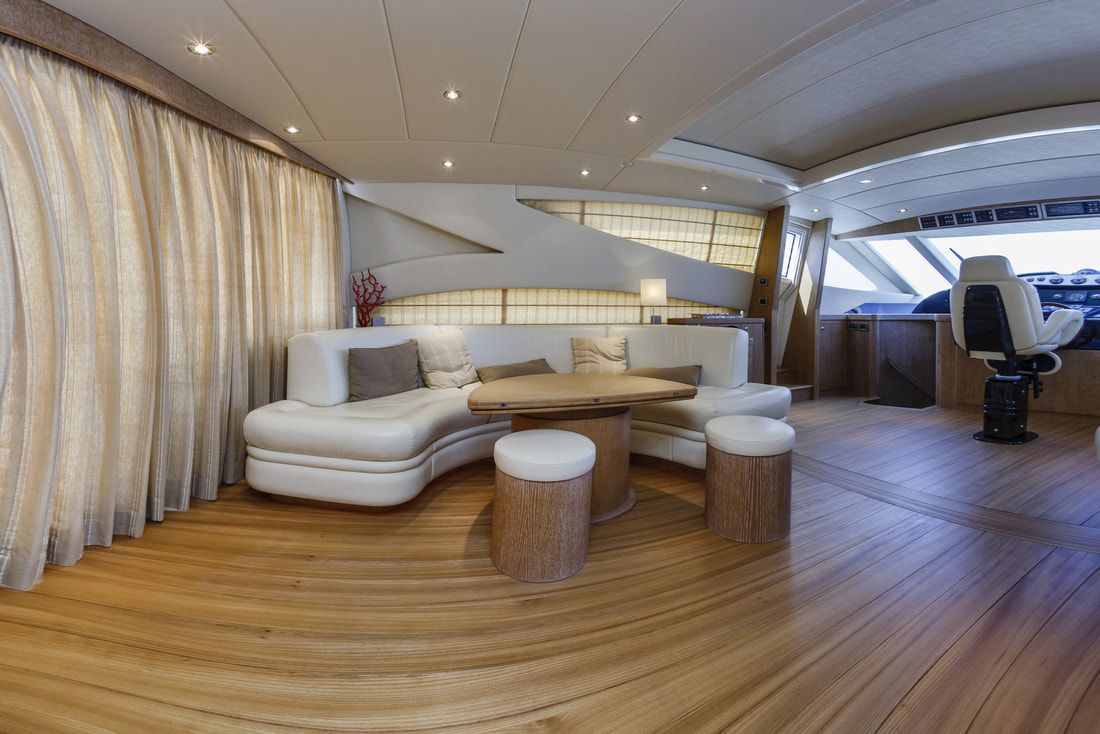 Large, ultra-modern Captain's Helm with custom teak flooring, and tables