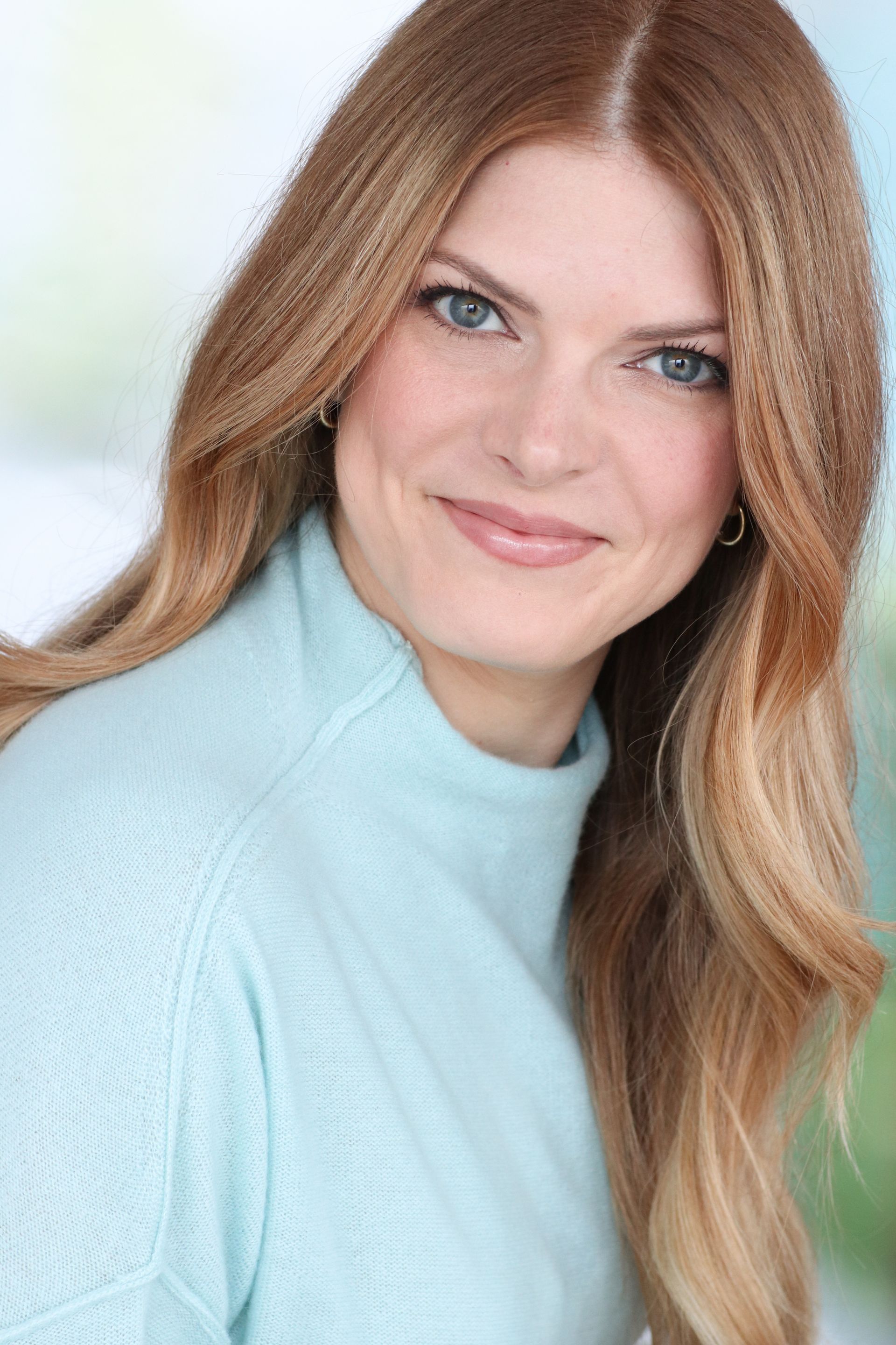 a Catholic therapist in a blue jacket and white shirt is smiling in Grapevine Texas