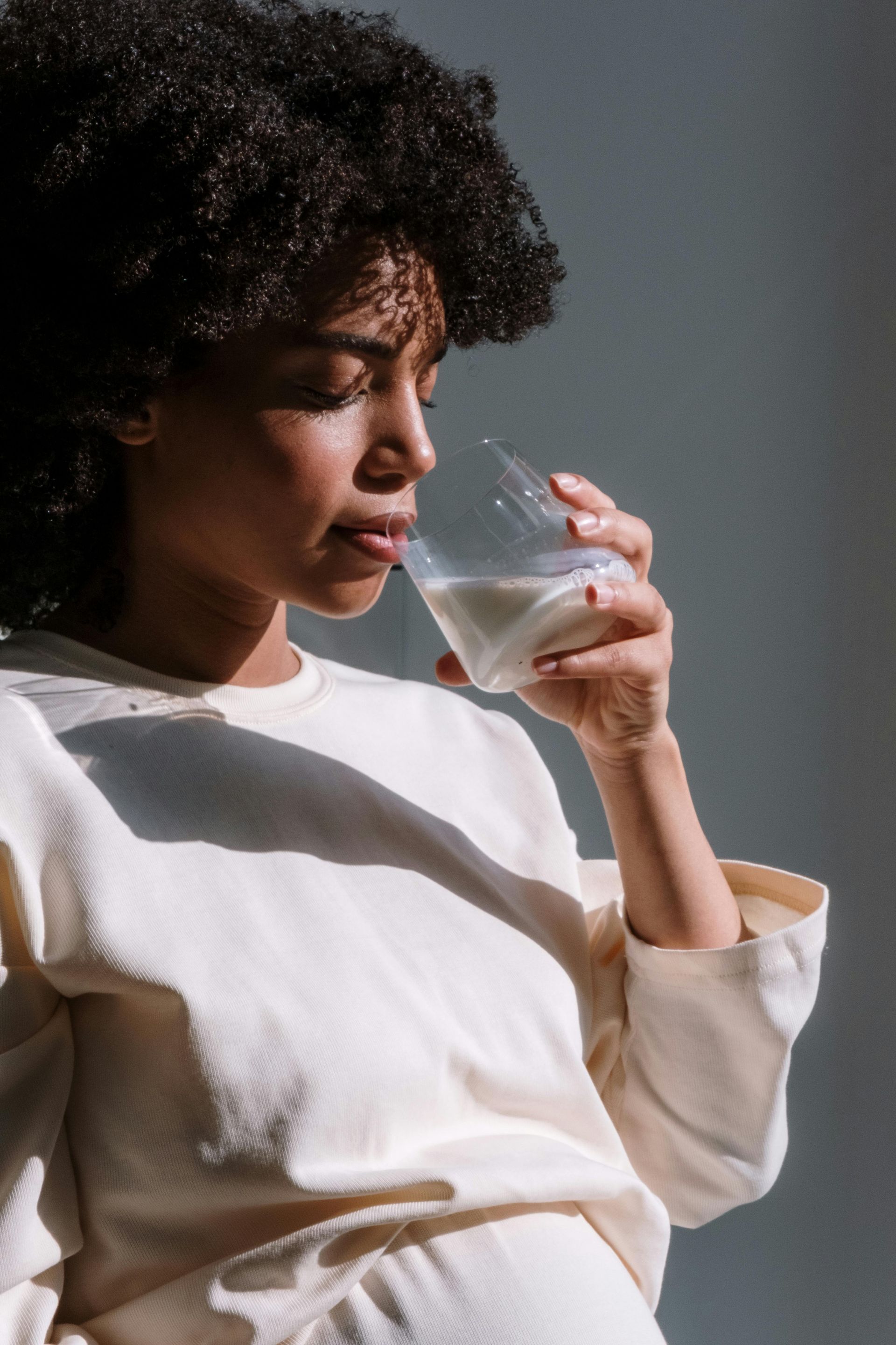 woman drinking water to hydrate as she focuses on perinatal mental health