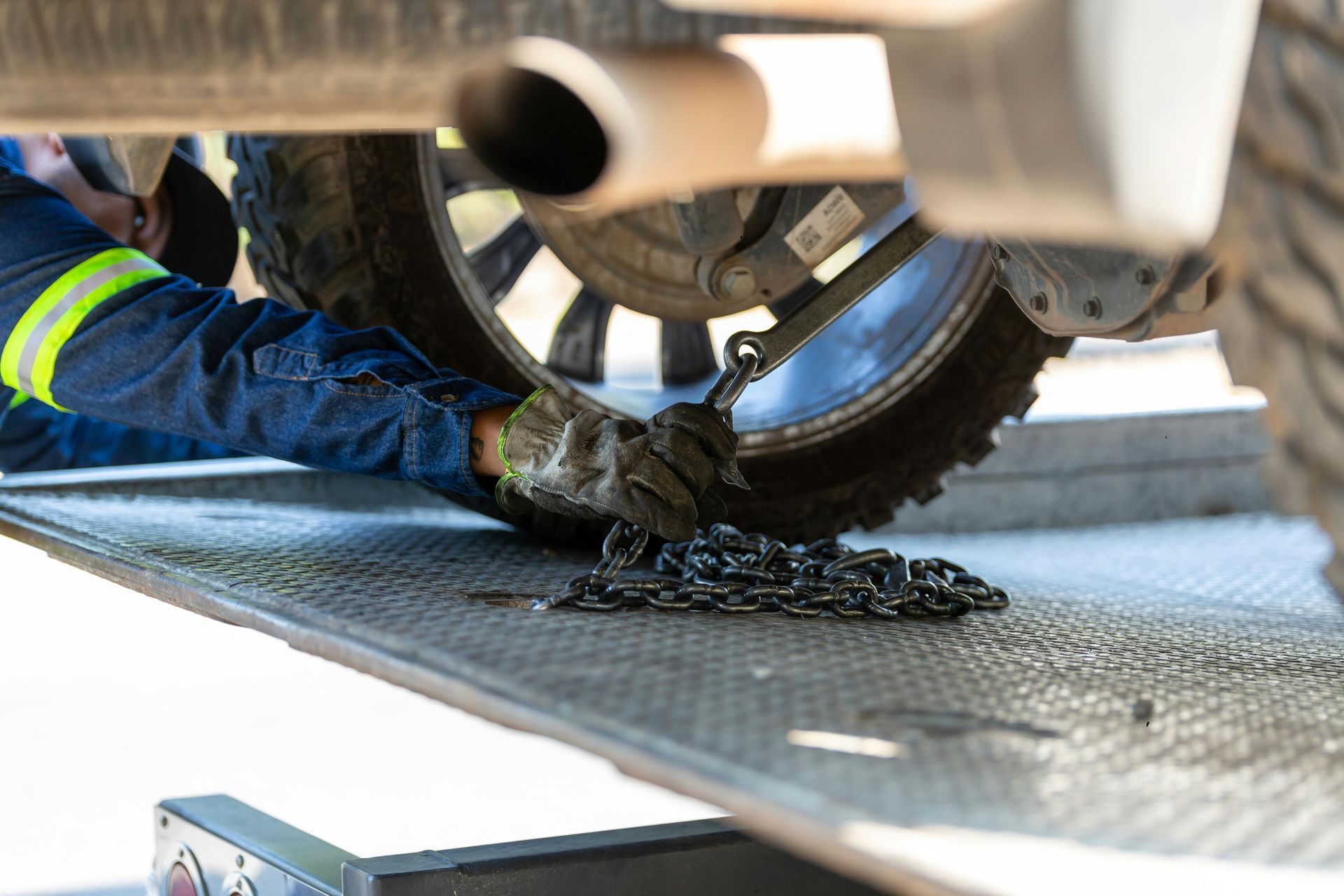 A man is fixing a tire on a tow truck.