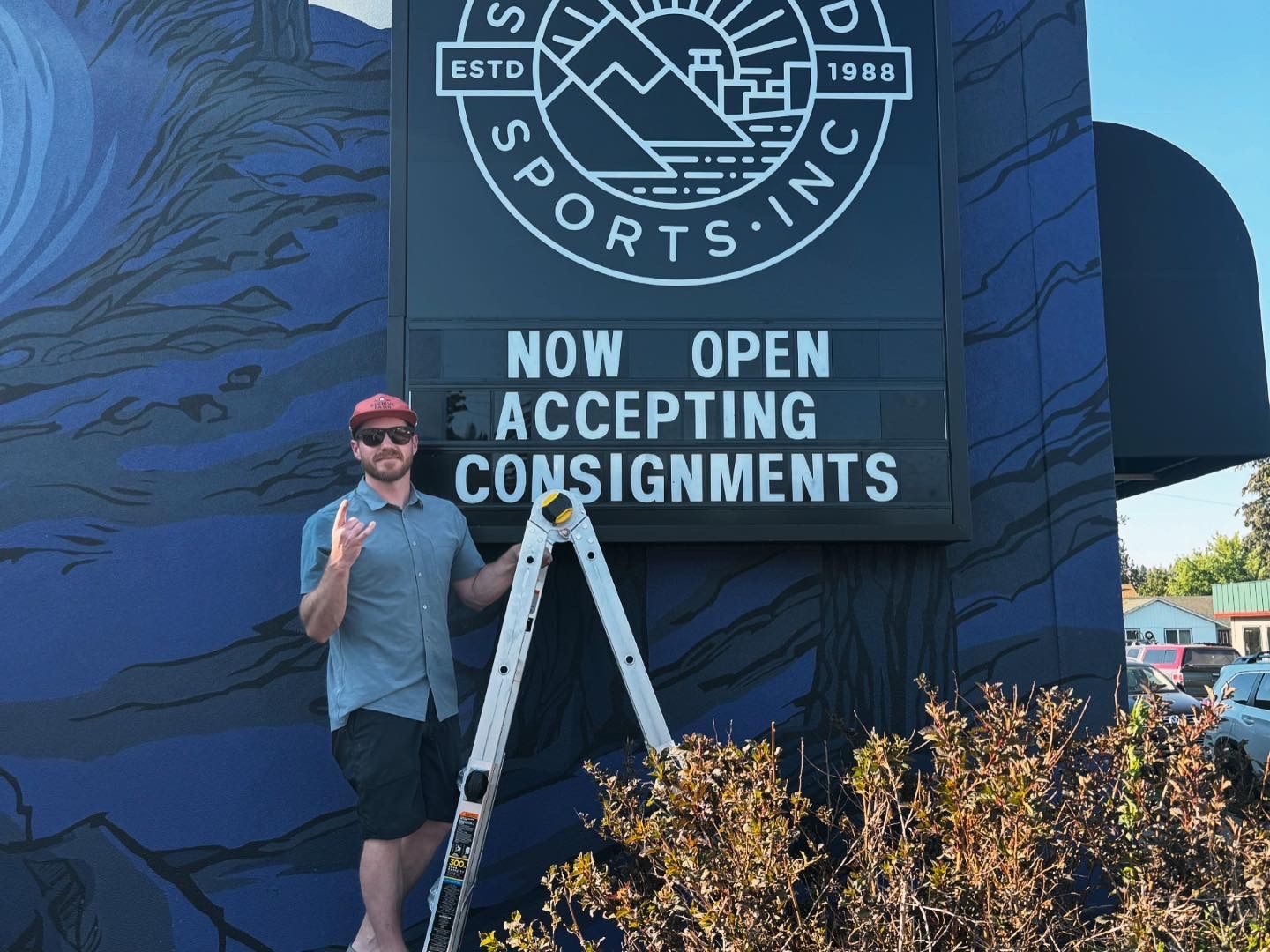 Two people standing in front of a second wind sports store