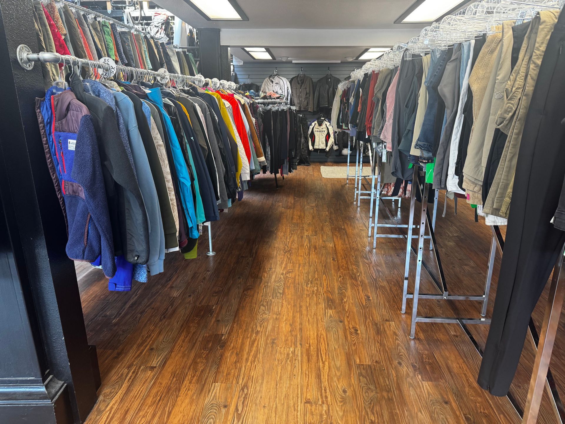 A store filled with lots of clothes hanging on racks.