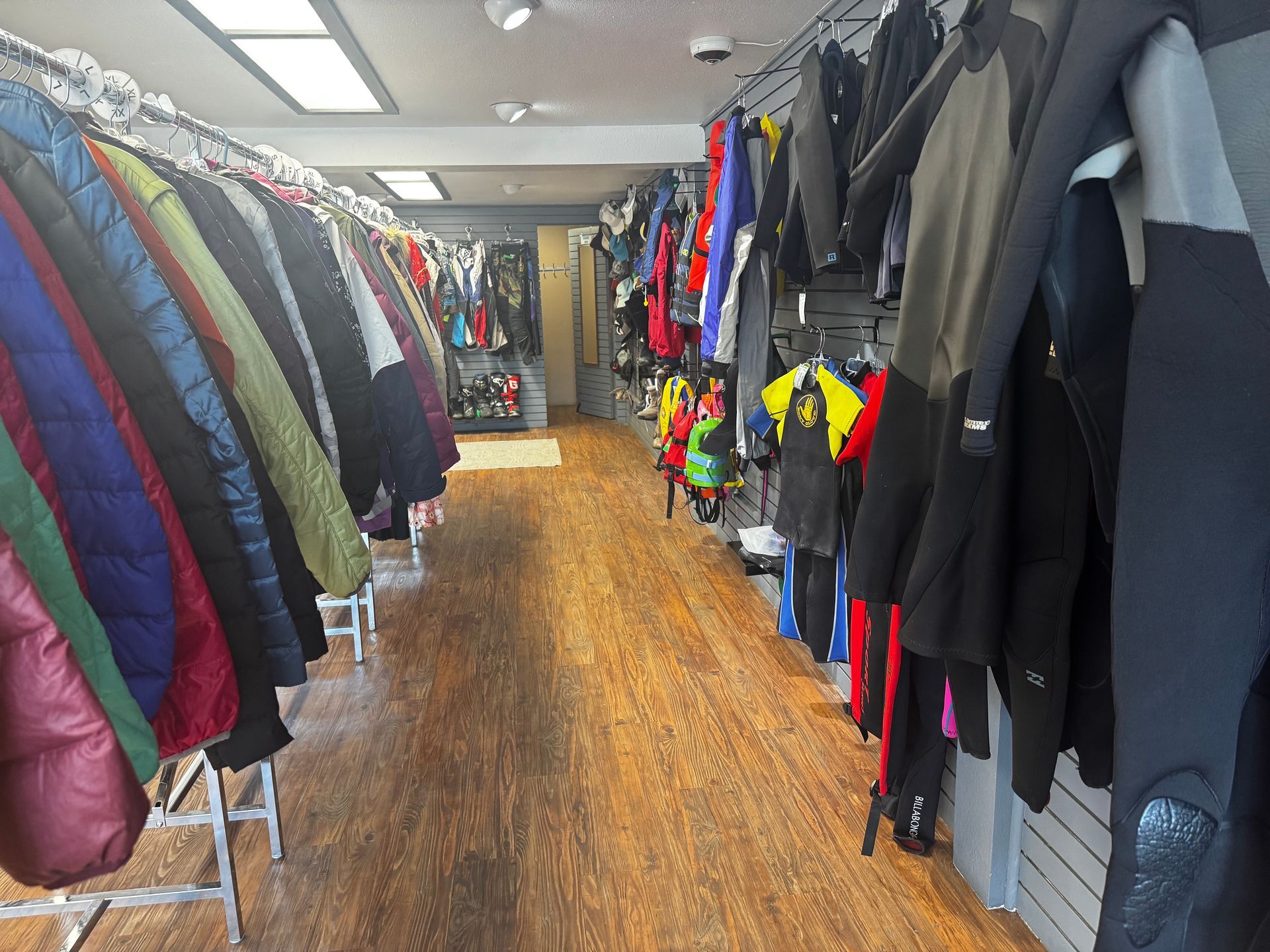 A store filled with lots of clothes hanging on racks.