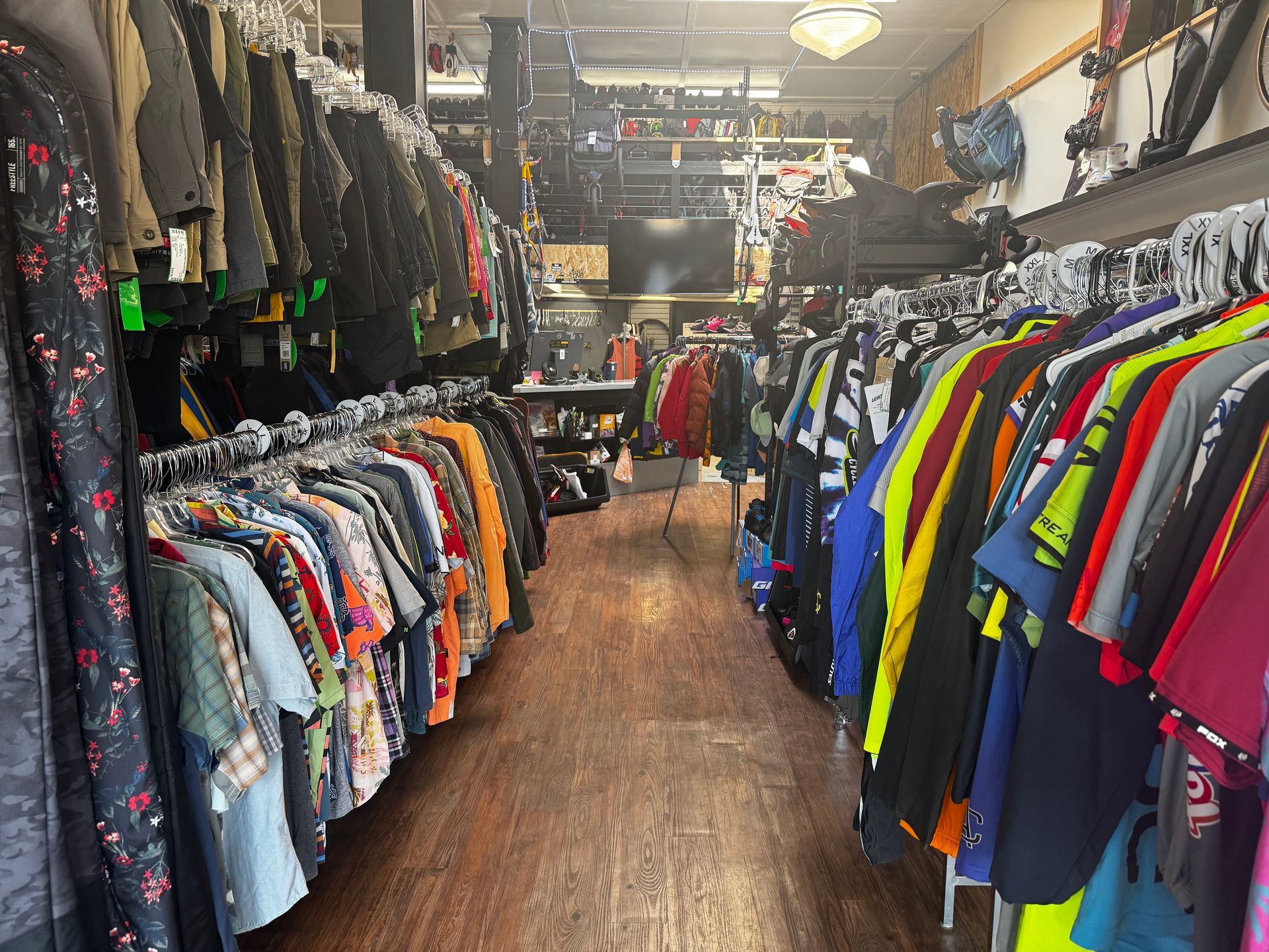A store filled with lots of clothes hanging on racks.